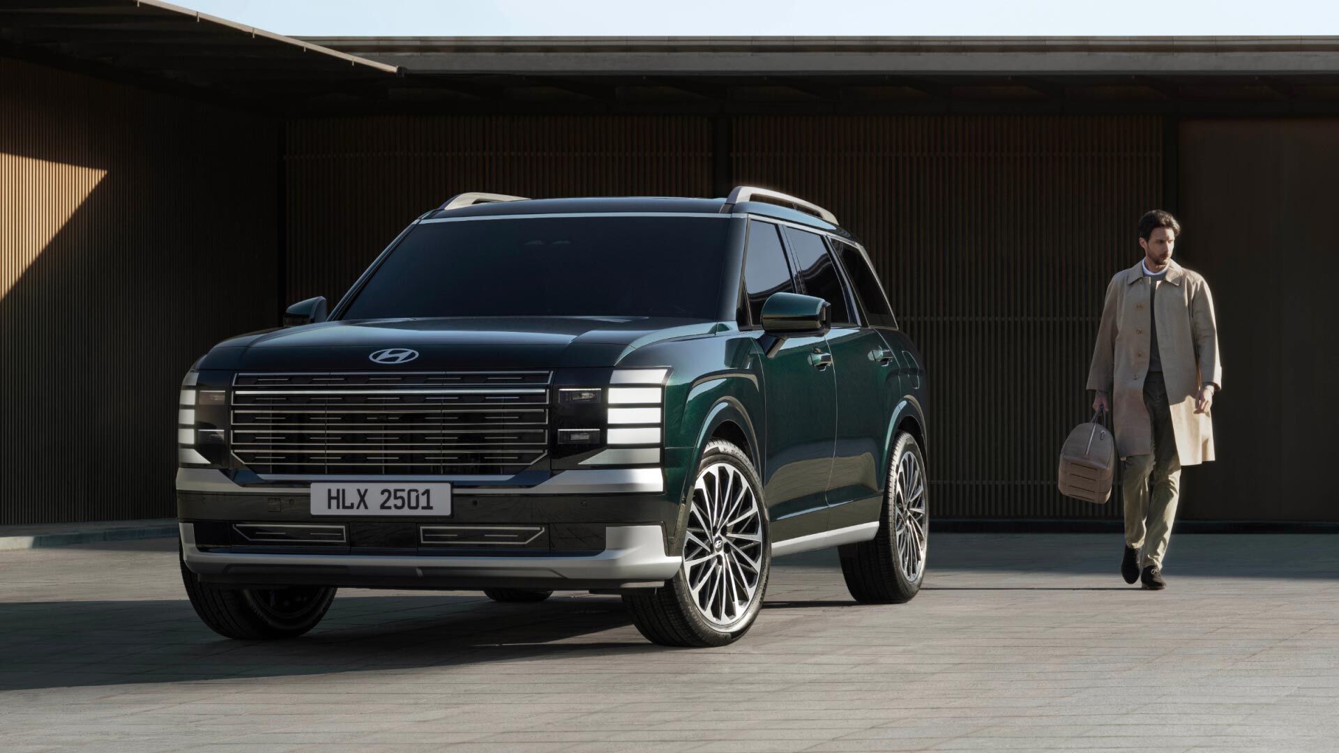 Side-front view of orange Grandi10 with lakeside view at night